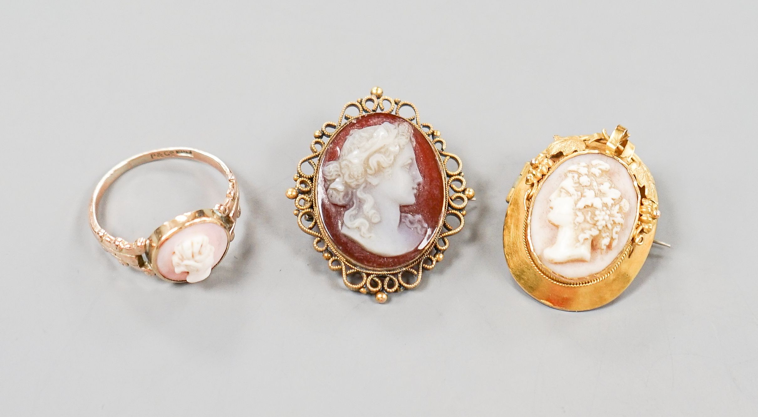 Two yellow metal and cameo set oval brooches, shell and hardstone cameo brooches and a 9ct cameo ring